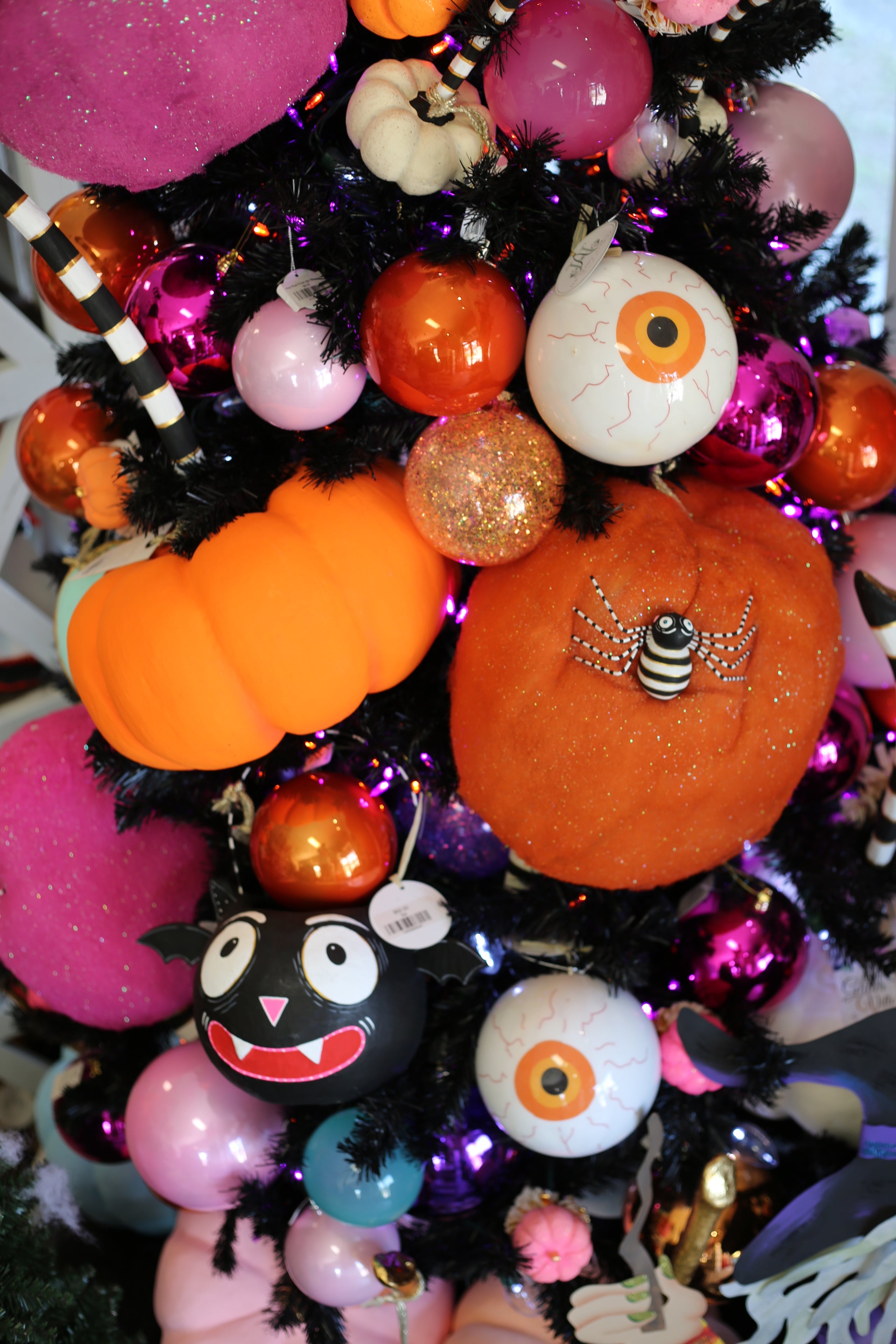 Halloween-themed decorative tree with pumpkins, eyes, and other festive elements.